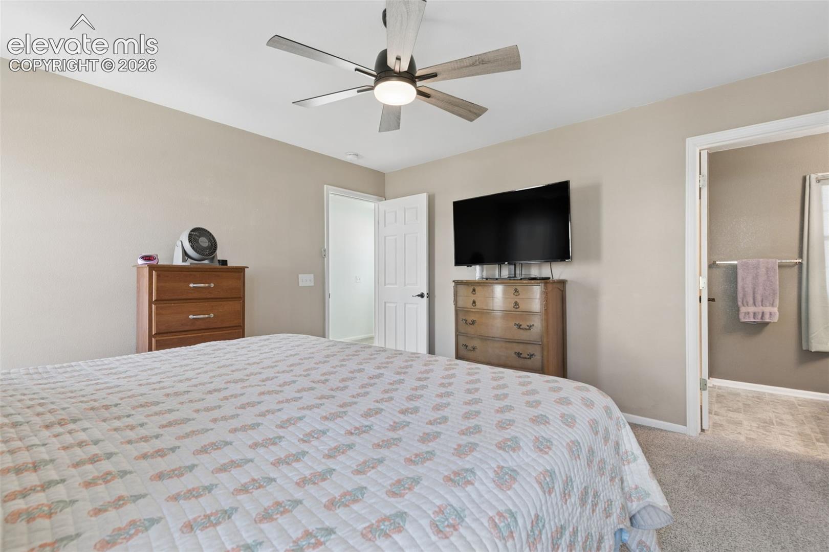 Recessed lighting with a ceiling fan, neutral wall tones, textured carpeting, and white trim