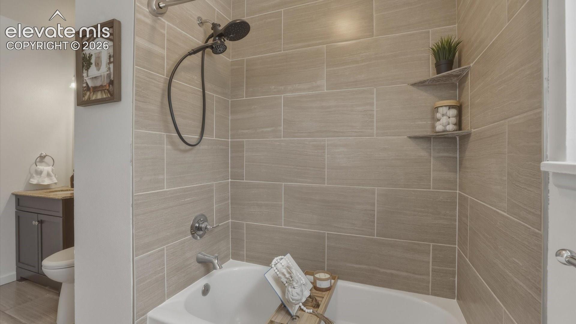 Tiled tub/shower in upper level Full Bathroom.
