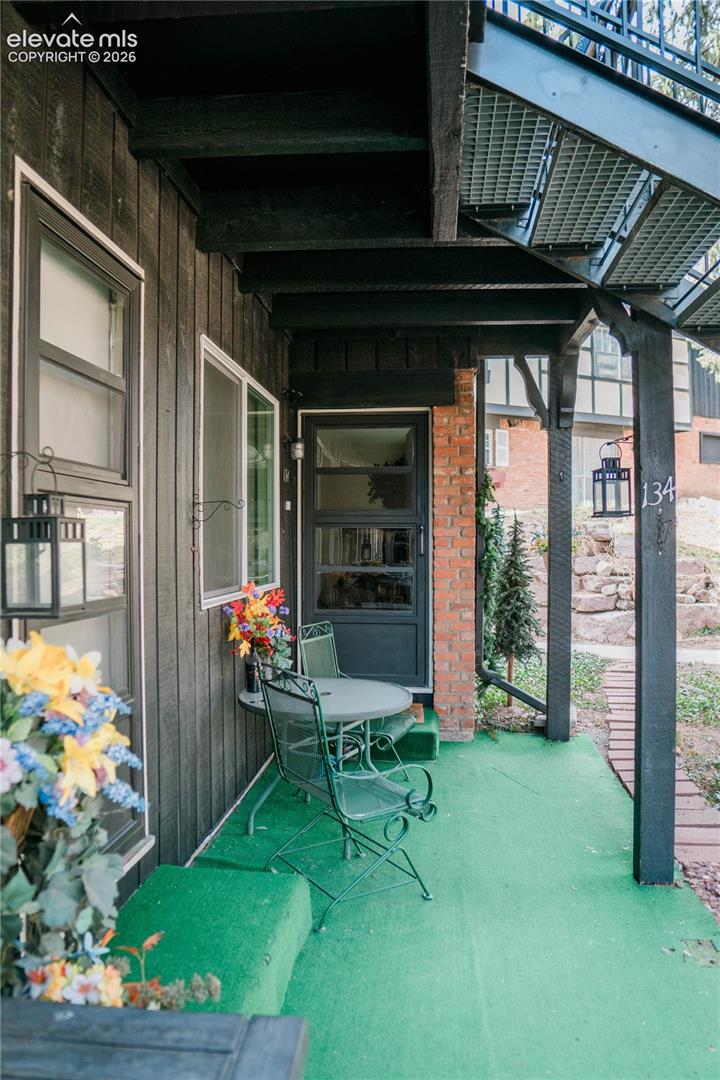Covered exterior entry with black siding