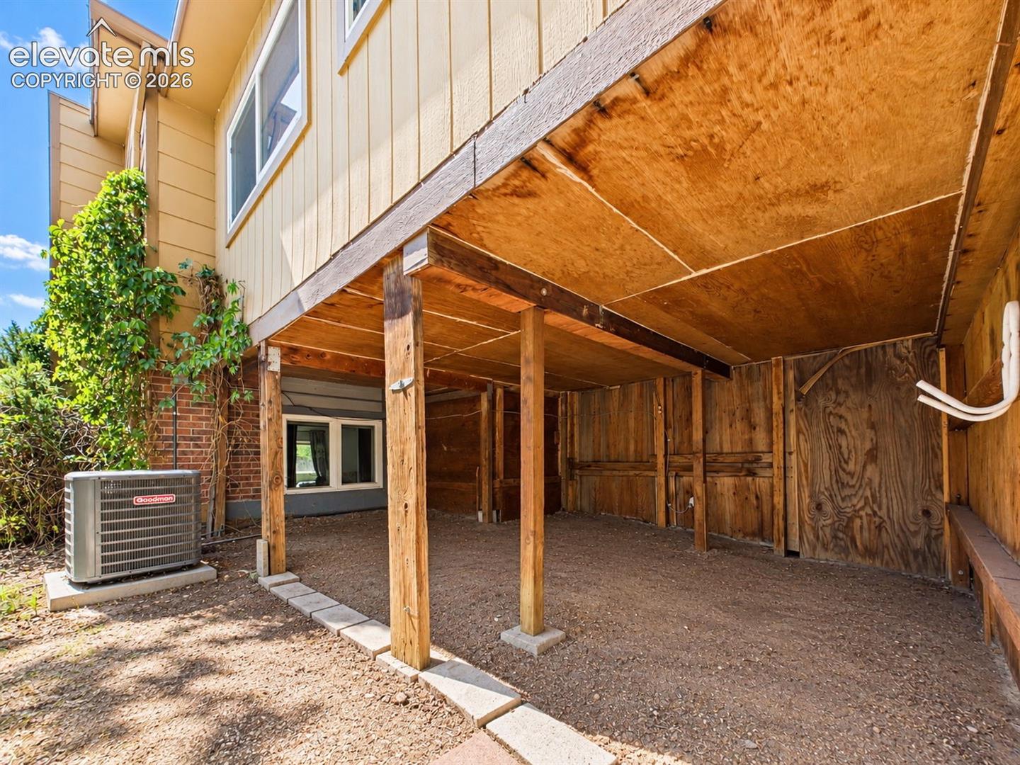 Sheltered area beneath the elevated portion of the home provides substantial space for outdoor storage and equipment.