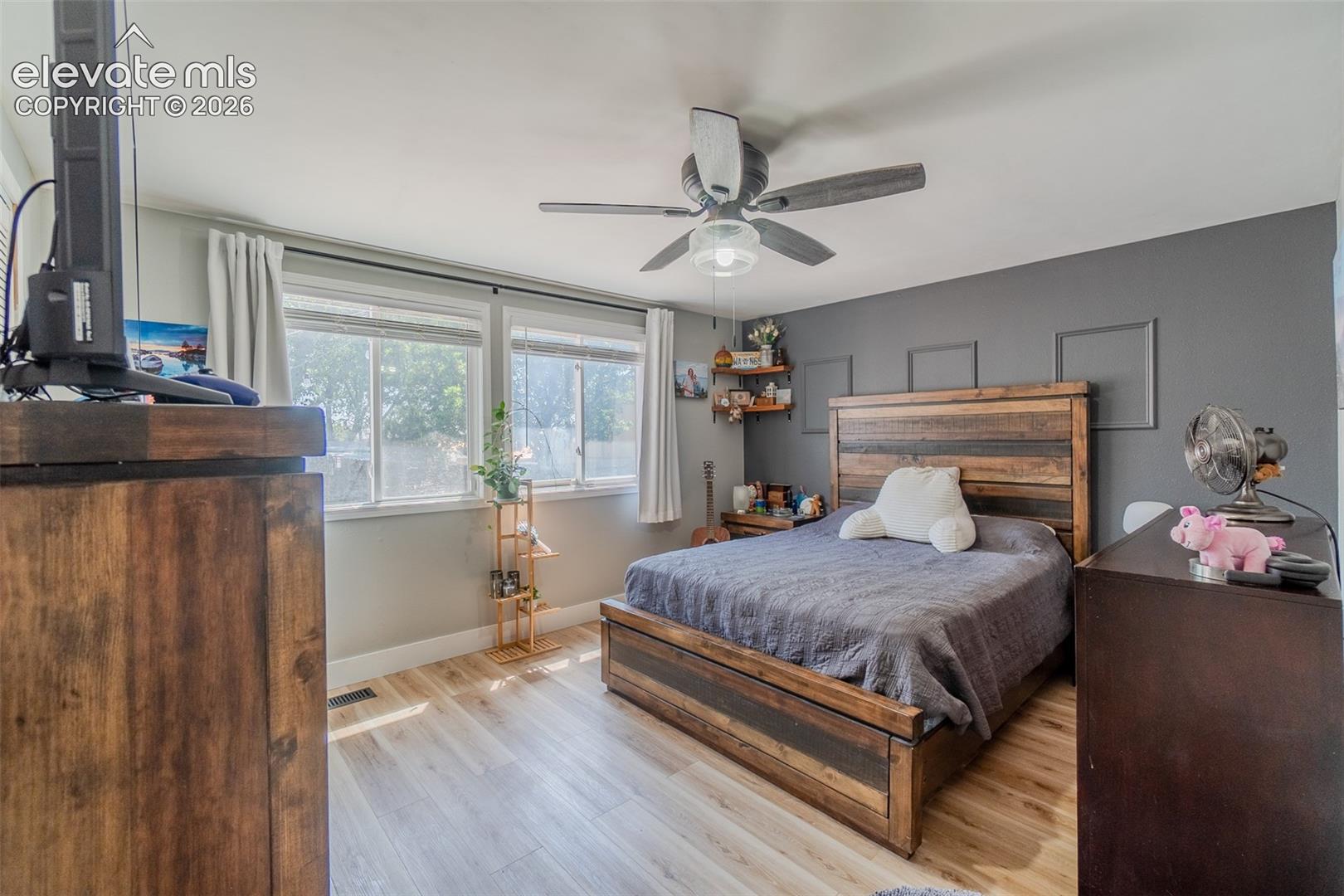 Room featuring light wood-finish flooring and a ceiling fan with integrated lighting