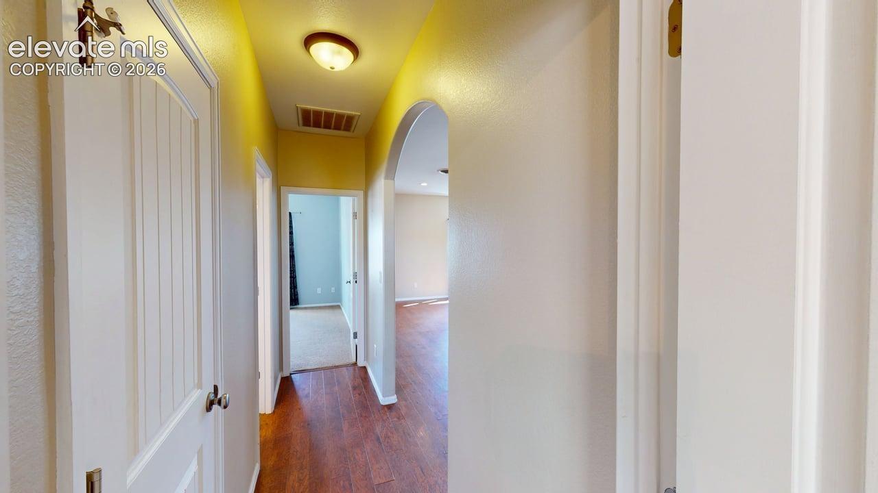 Wood-finish flooring throughout the hallway