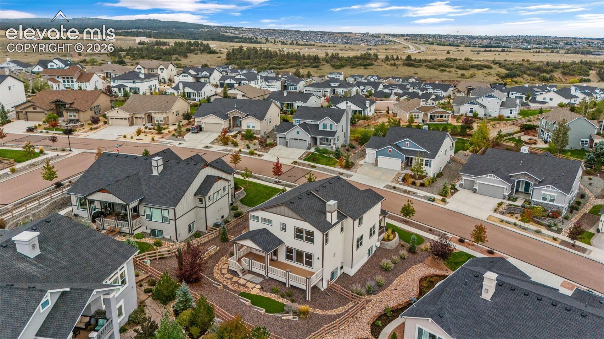 Expansive residential community featuring diverse architectural styles, paved roadways, and landscaped properties