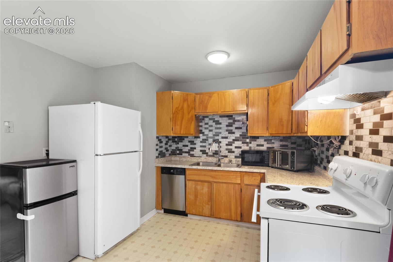 Kitchen with included stove/range, dishwasher, and refrigerator 