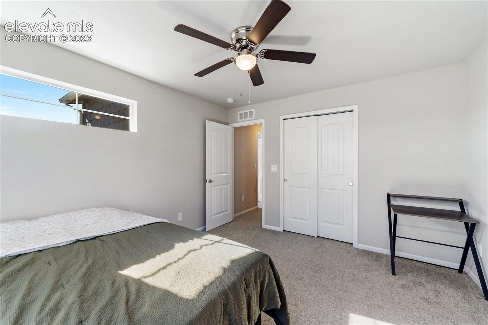 Well-sized secondary bedroom with closet storage.