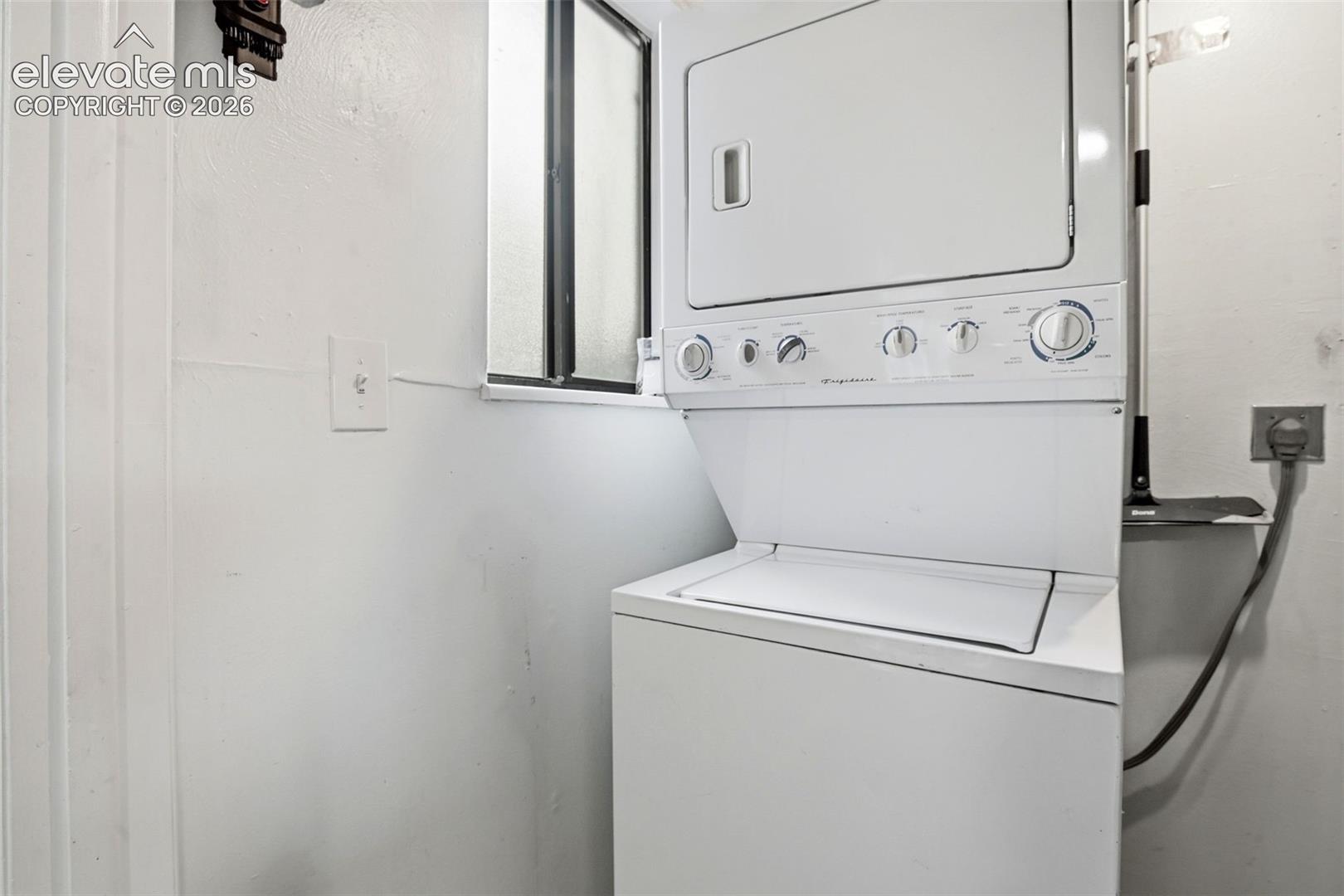White stacked washer and dryer unit