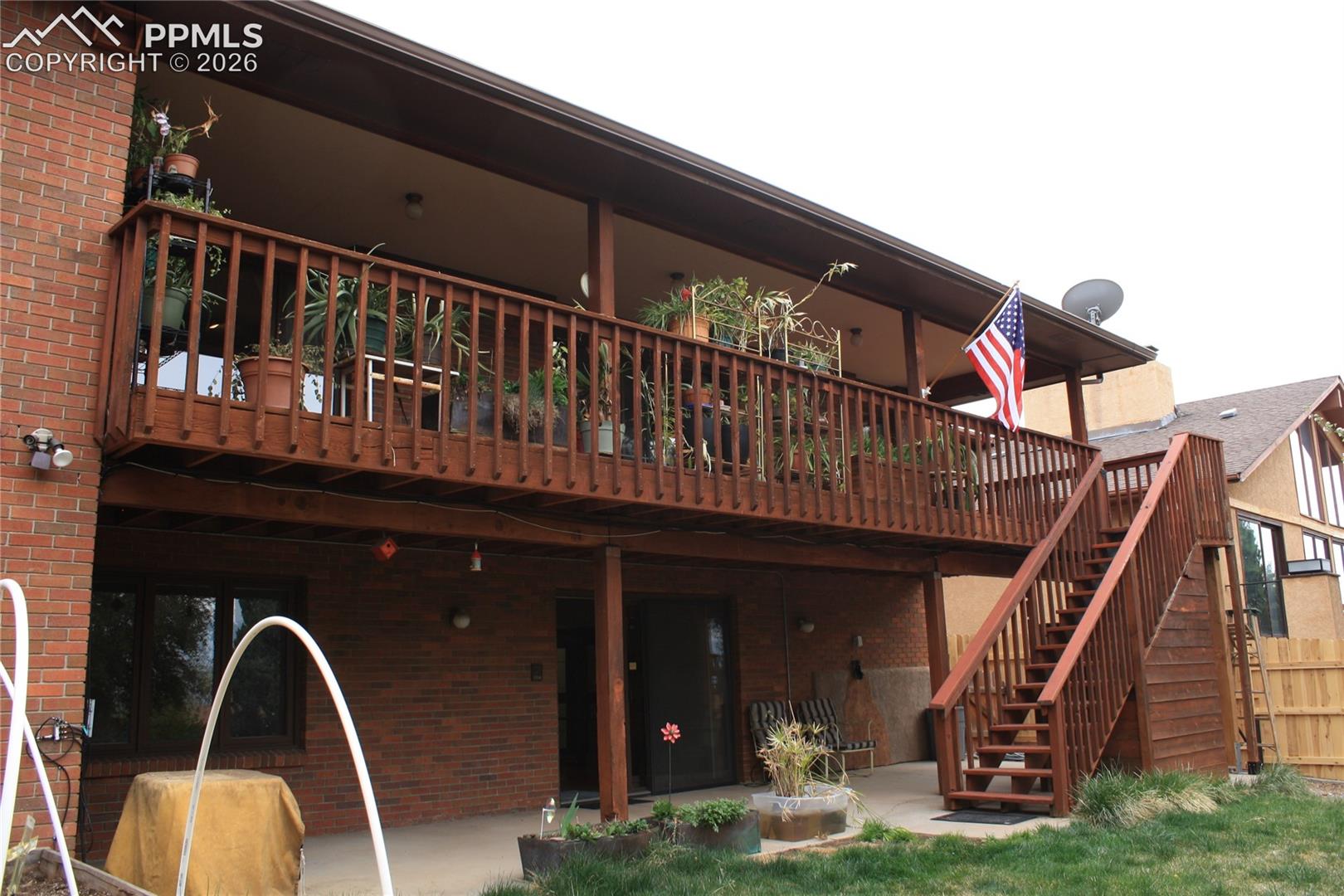 Main level covered deck, lower level patio covered patio & hidden shed under stairs