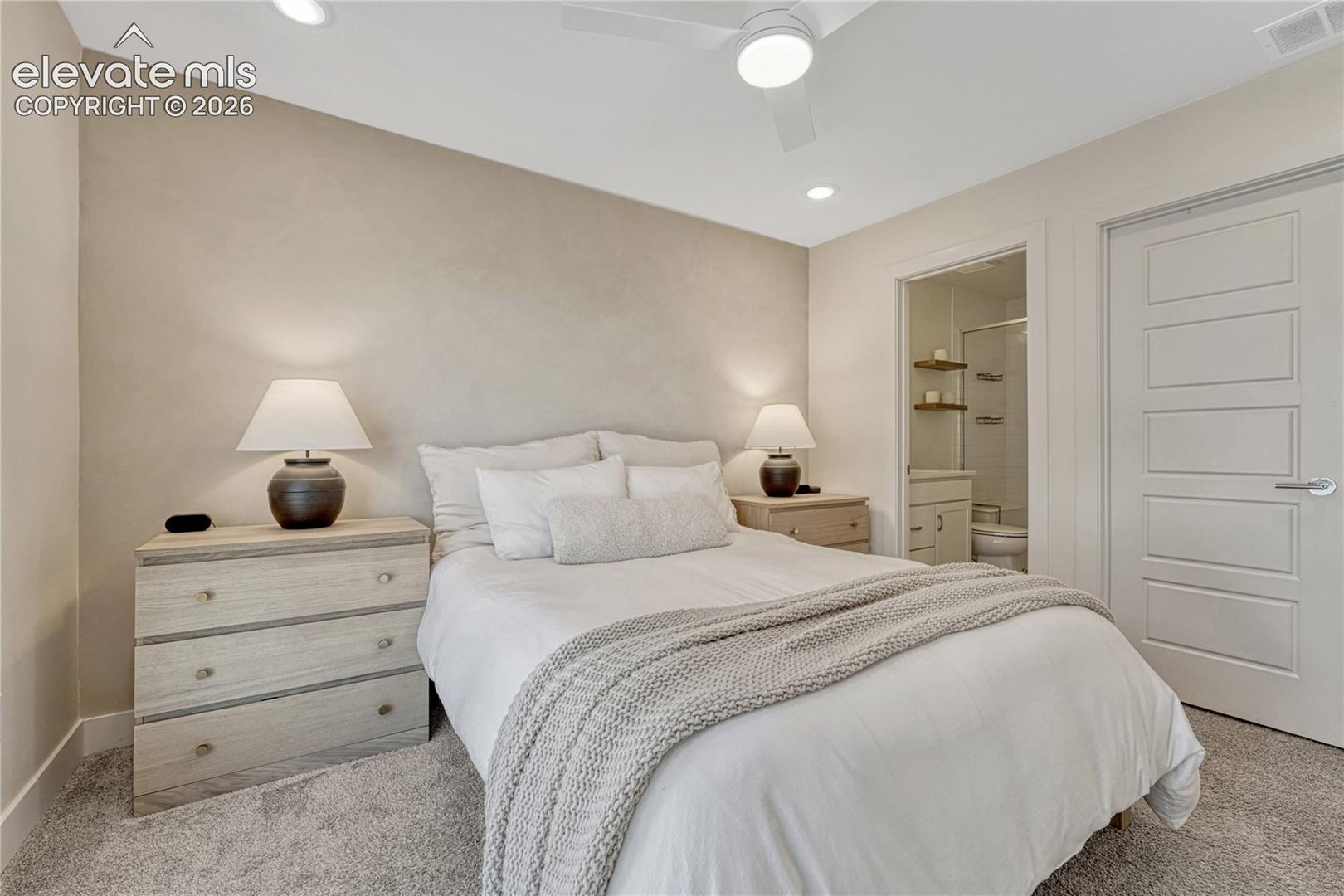 Neutral interior space featuring carpeting, a white five-panel interior door, recessed lighting, and a white ceiling fan