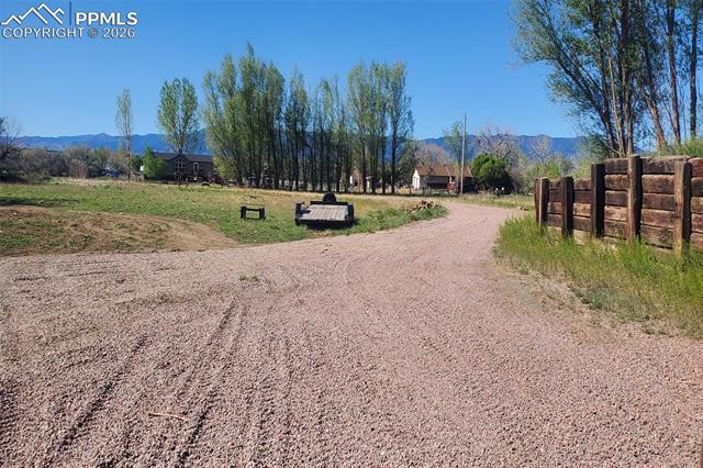 This view south shows the front half of the lot facing the street and views of the Wet Mountains.