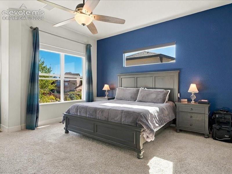 Recessed lighting and a ceiling fan fixture complement the room's illumination