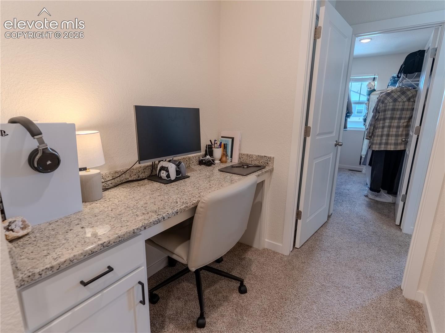 desk area with view of Primary closet 