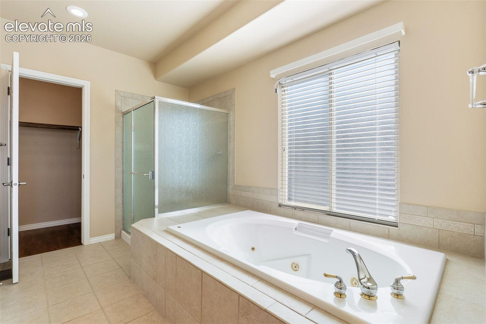 PRIMARY ENSUITE BATHROOM WITH JETTED SOAKING TUB AND WALK-IN SHOWER