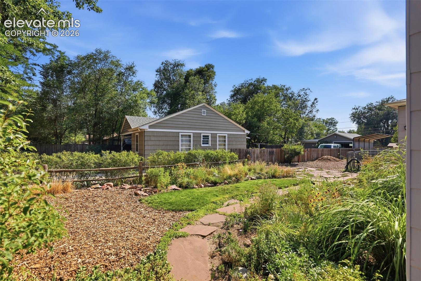 Exterior featuring flower beds and flagstone paving.