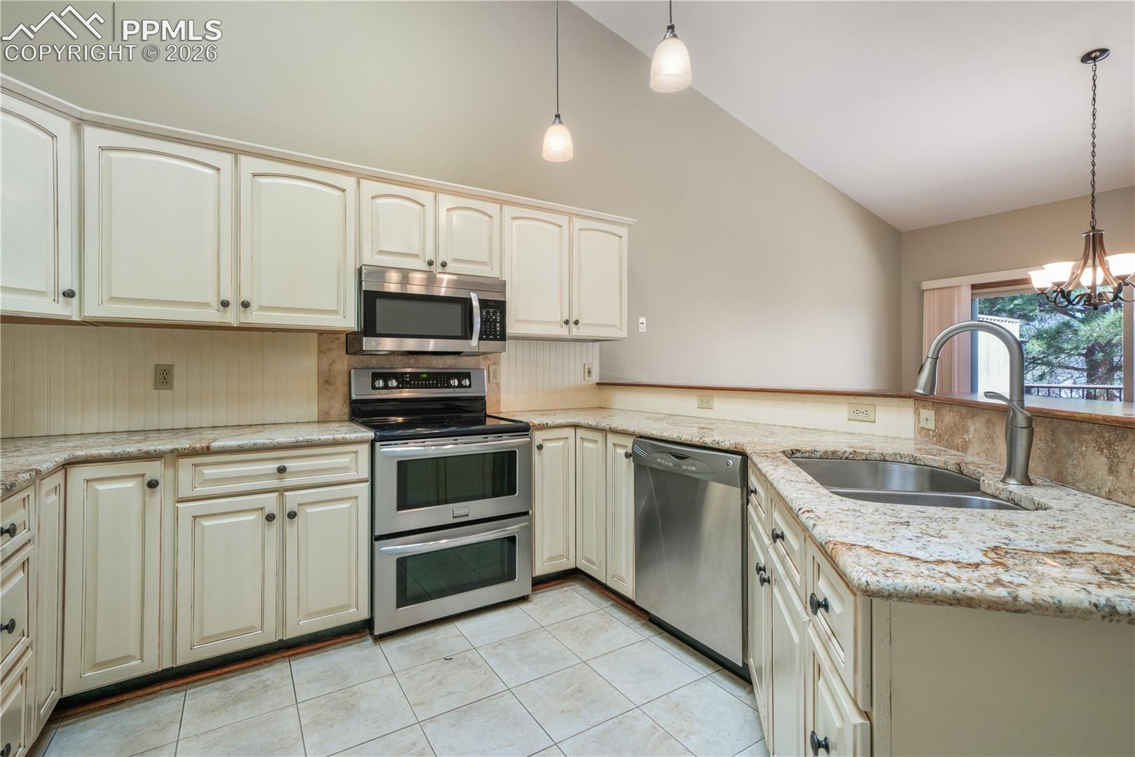 Kitchen with additional bar seating, hard wood floors, updated appliances and granite countertops 