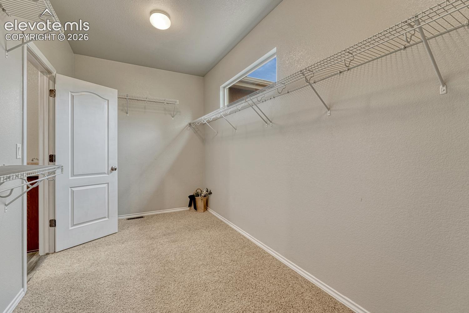 Primary Bedroom walk-in closet with direct access to the Laundry Room.