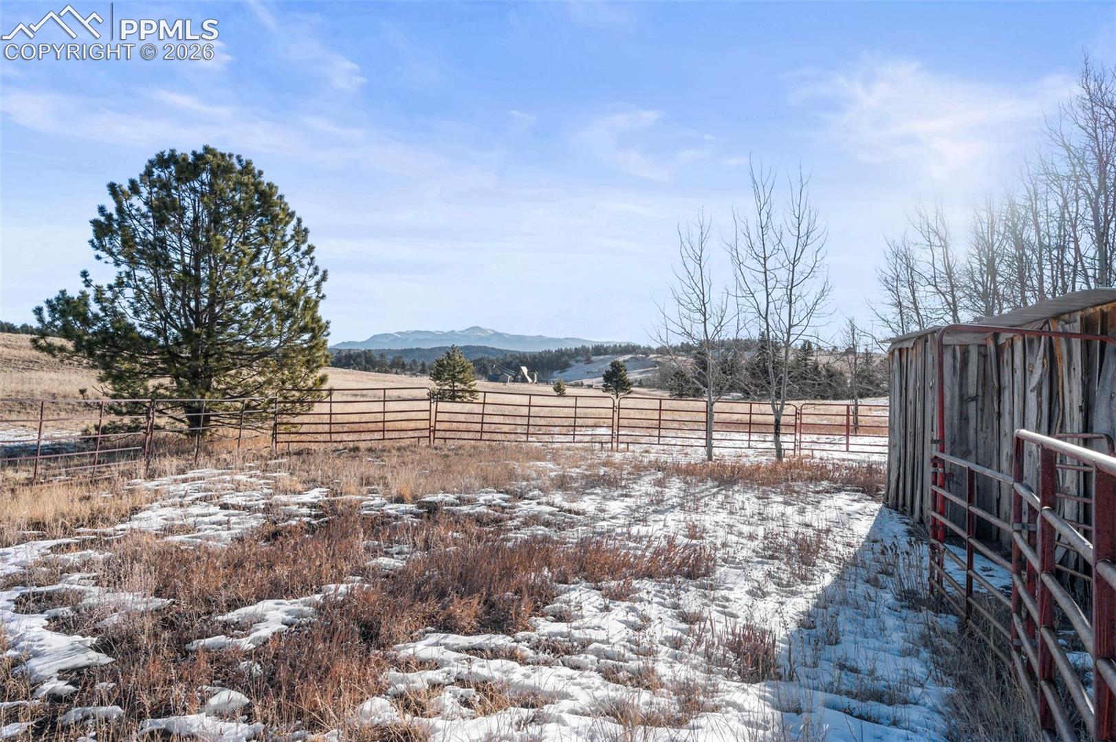 Yard covered in snow with a rural view