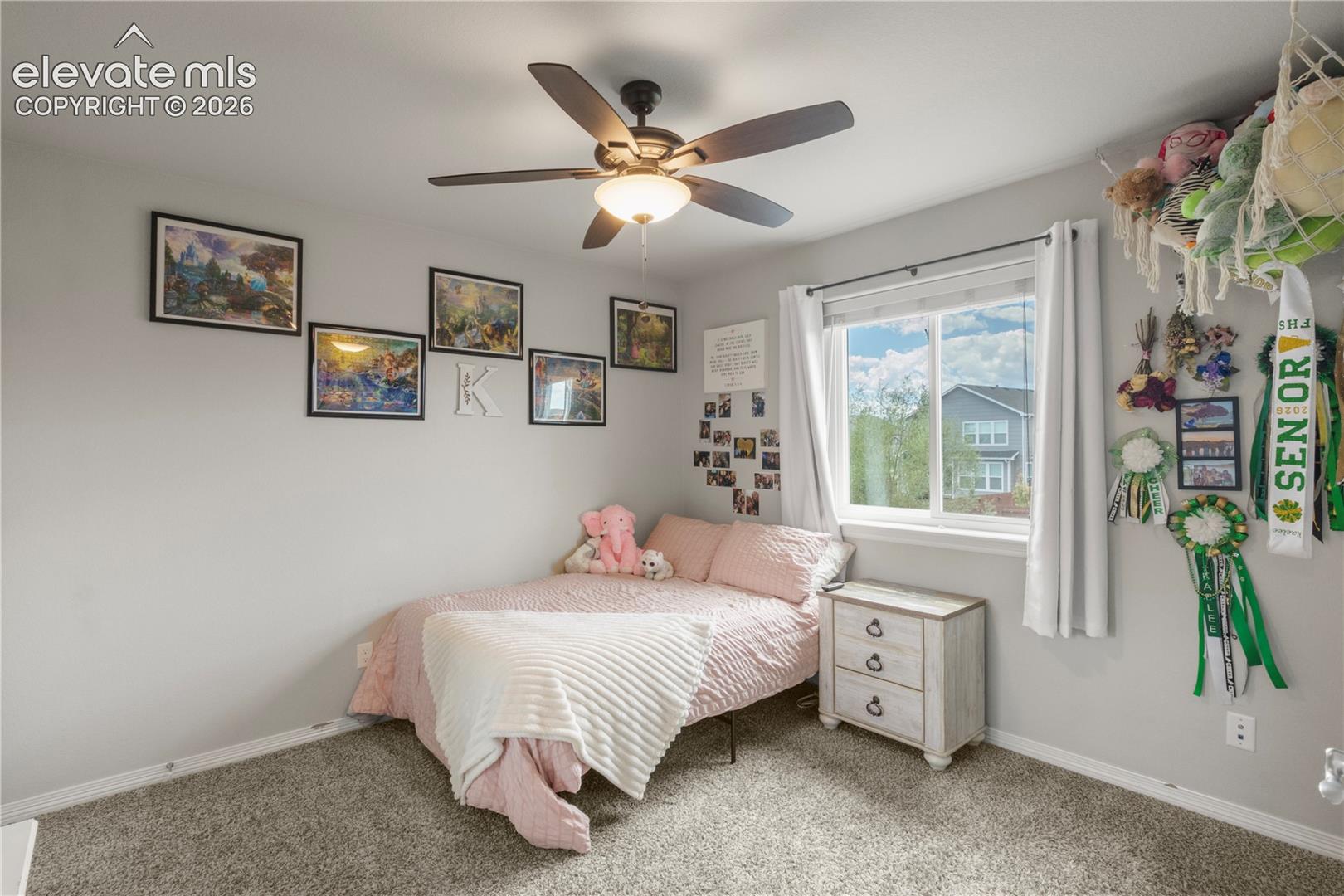 Ceiling fan with integrated lighting, wall-to-wall carpeting, single window with white trim, light gray painted walls