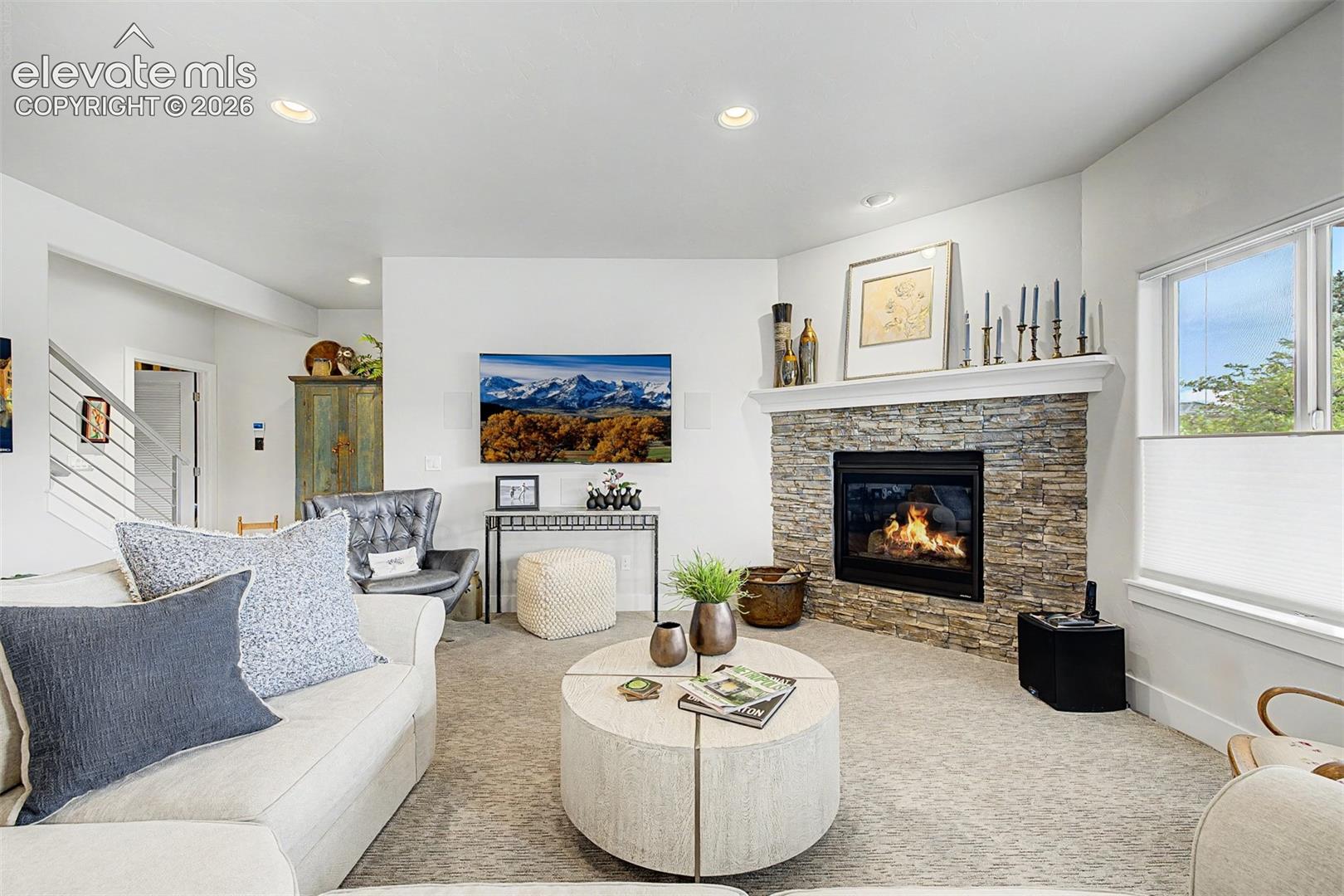 Large family room with beautiful fireplace and lots of natural light.