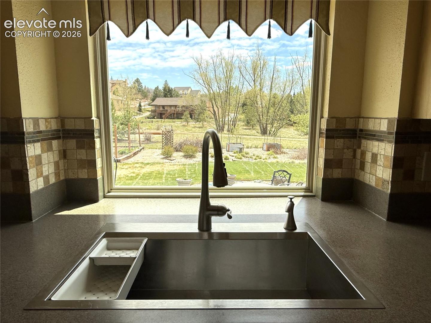 Beautiful Stainless Sink Overlooks the Yard and Open Space