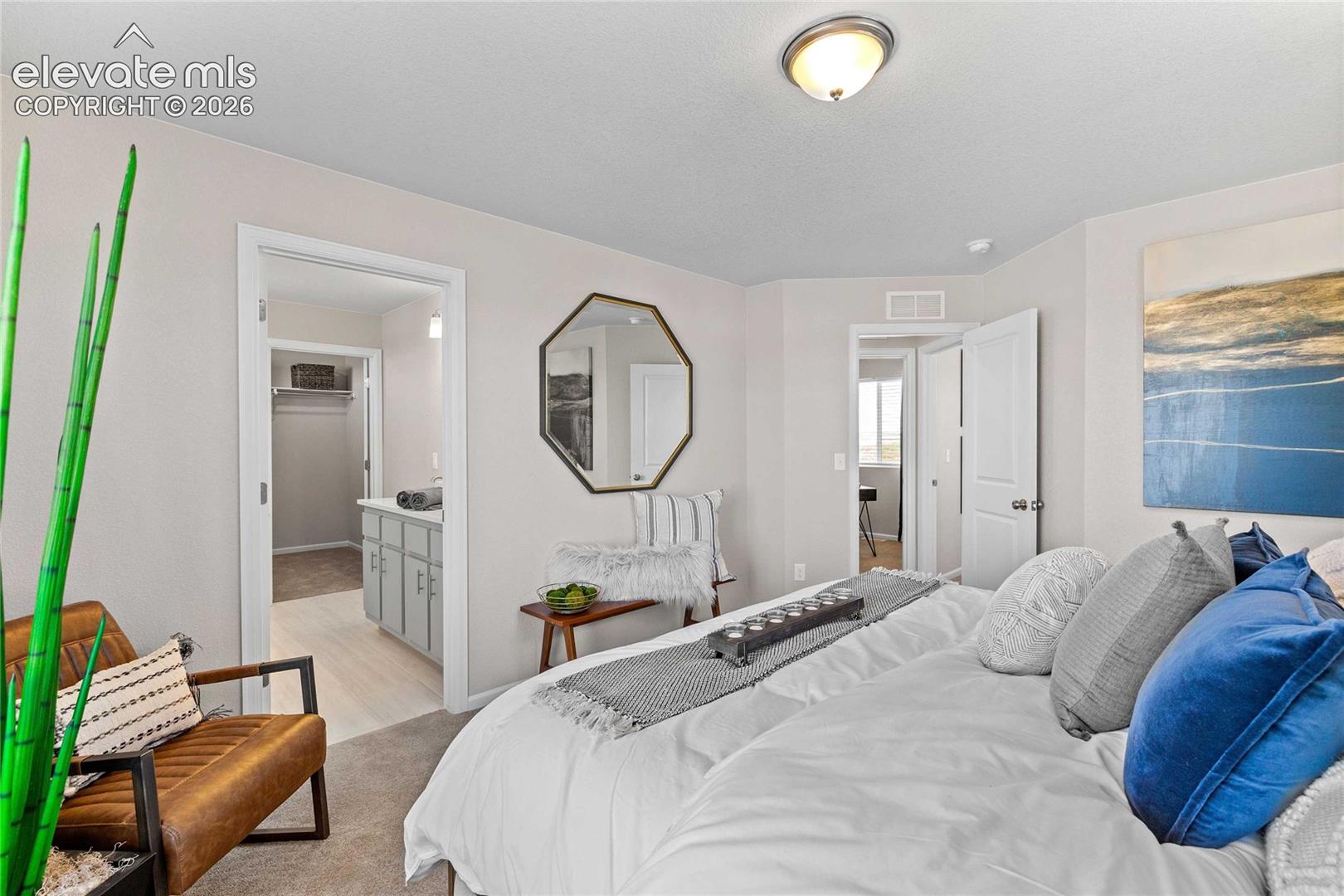 Carpeted bedroom with a surface-mount light fixture
*photos of a model home*