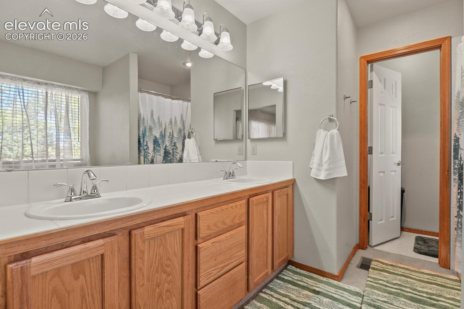 Double sink in bathroom attached to the Primary Bedroom.