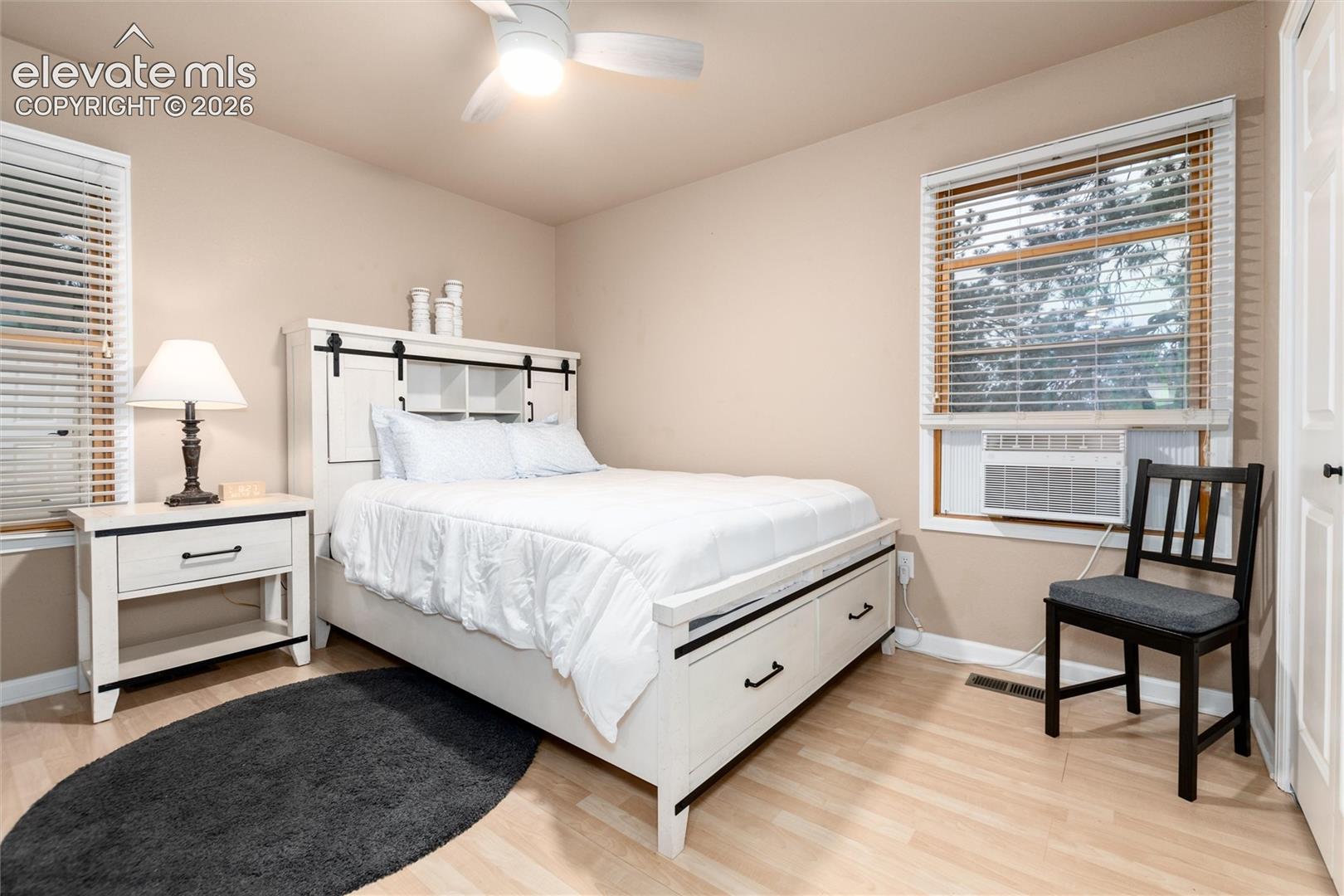 Light wood-finish flooring complements neutral wall tones