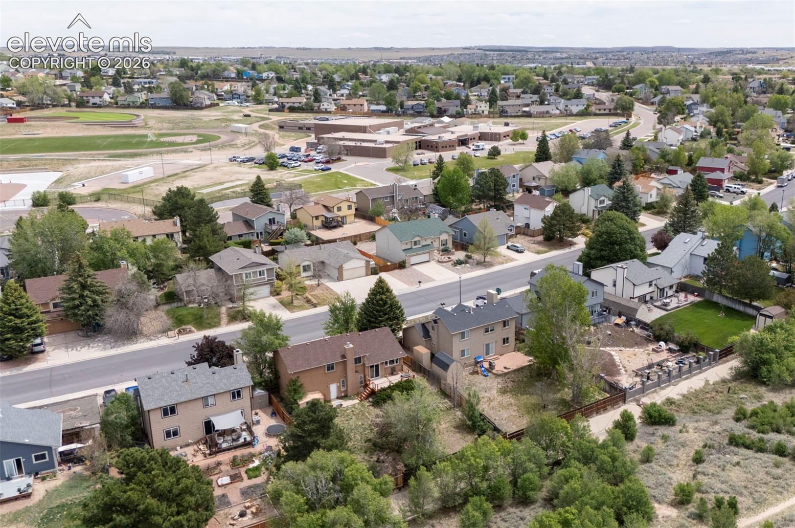 Residential neighborhood featuring a mix of single-family homes, mature trees, and paved streets