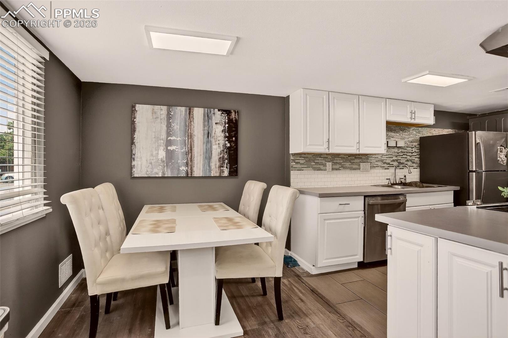 "Bright and welcoming dining room with plenty of natural light, perfect for gatherings! 
