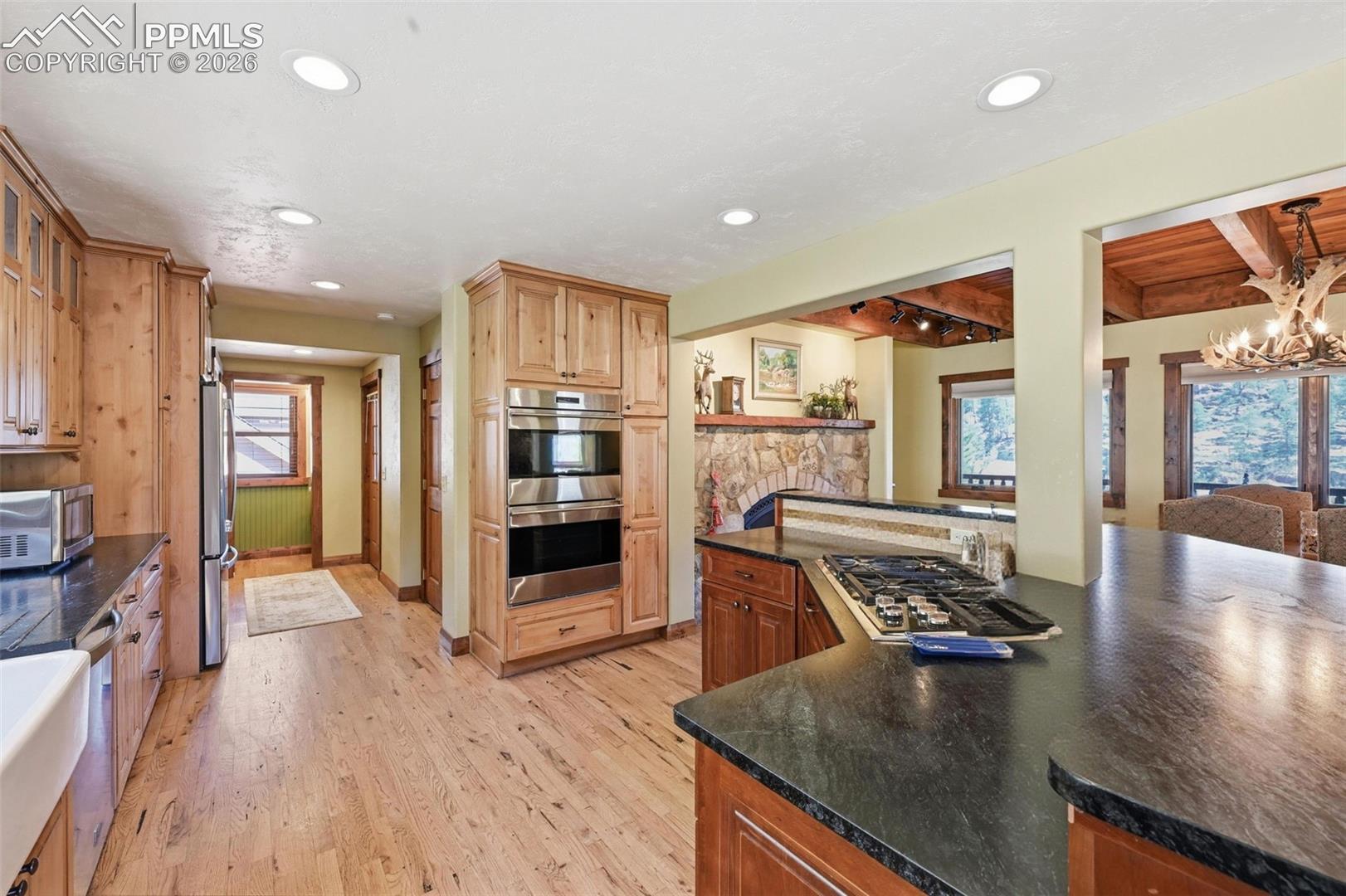 This elegant kitchen hosts a dual ovens, and a propane gas range among other upgraded appliances. 