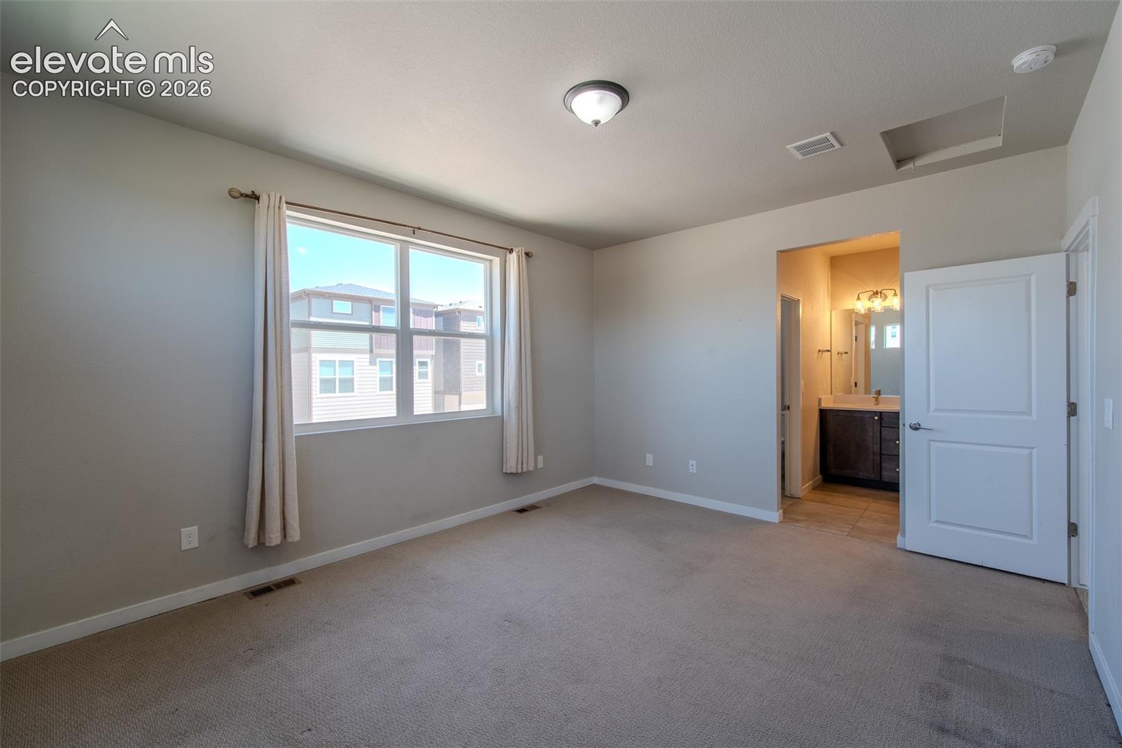 The Upper Level Primary Bedroom is a private retreat with a walk in closet and adjoining bathroom.