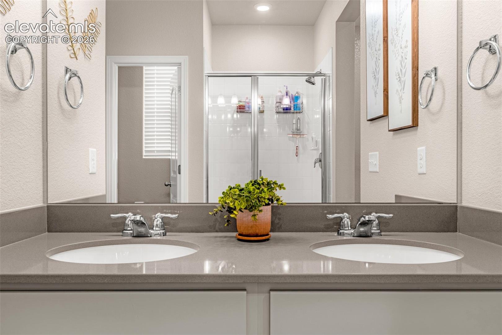 Dual undermount sinks, chrome faucets, and a solid surface countertop