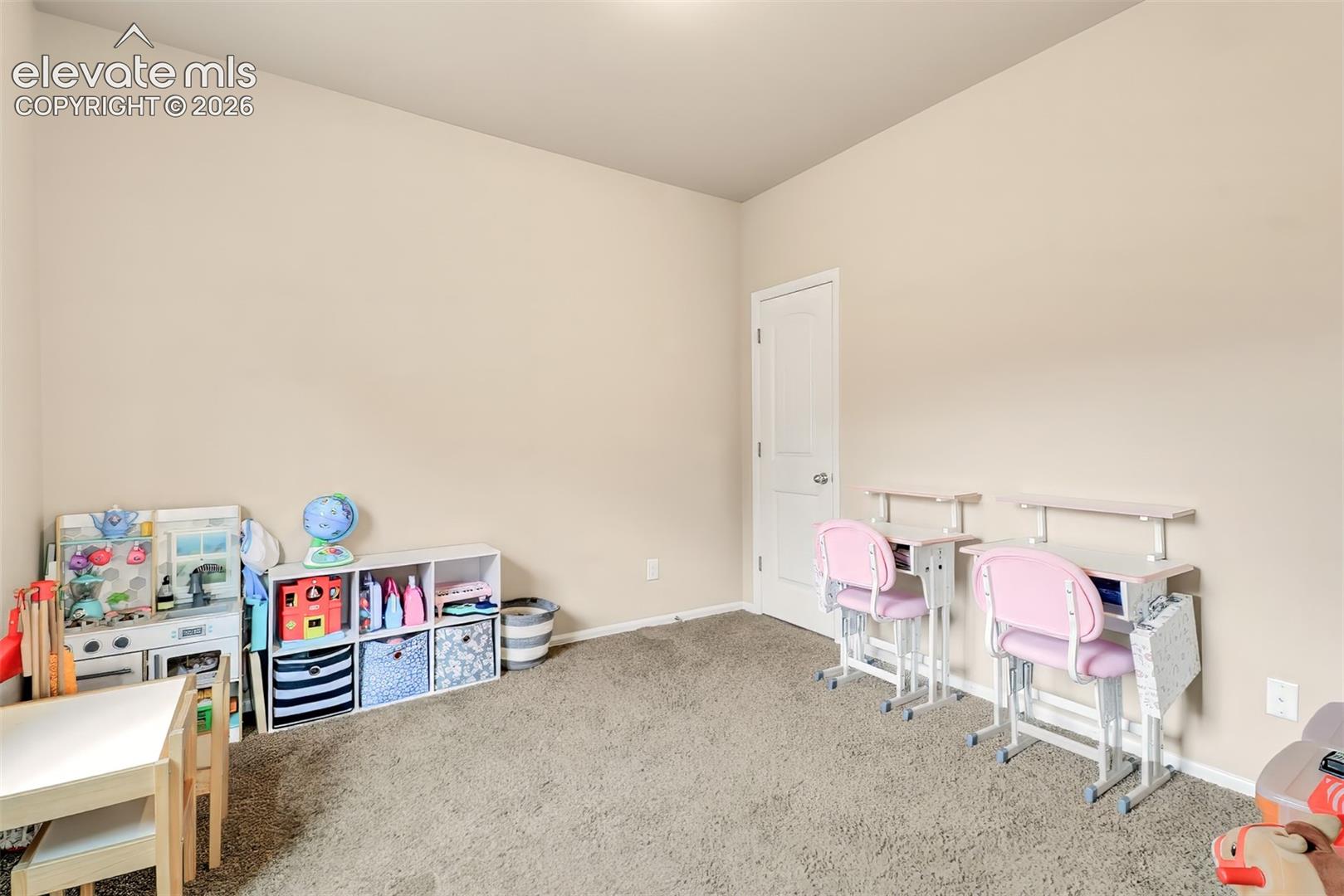 Neutral wall tones, wall-to-wall carpeting, and a single-panel interior door
