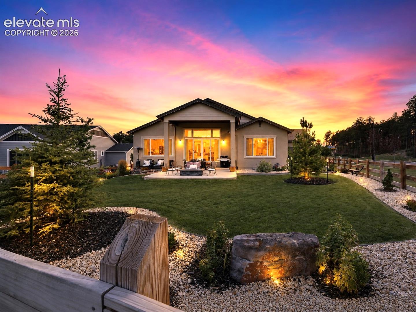 YOUR OWN SLICE OF COLORADO PARADISE — From the emerald-green lawn to the custom patio, every element of this expansive backyard invites you to slow down, entertain, and enjoy the beauty of outdoor living.