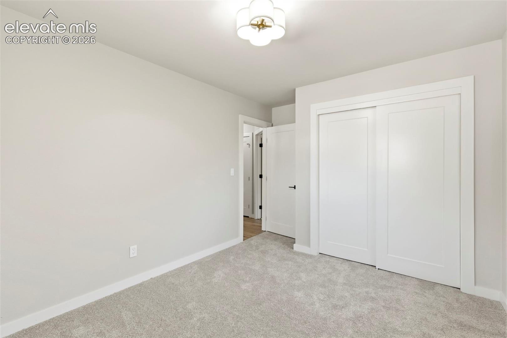 Light-toned walls complement plush carpeting