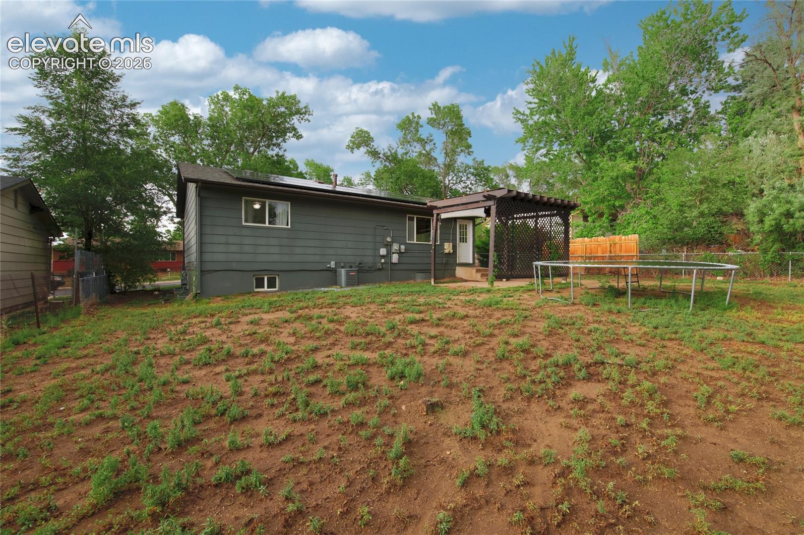 Spacious rear grounds with mature tree-lined perimeter and established vegetation