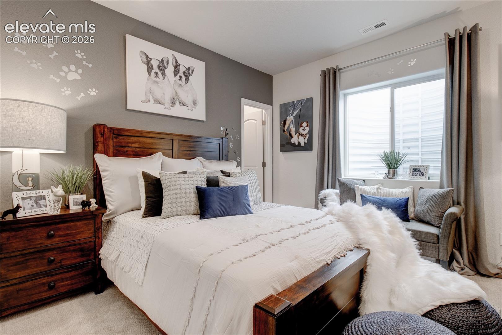 Neutral-toned room featuring a single-panel interior door and a dual-pane sliding window with neutral-toned curtains