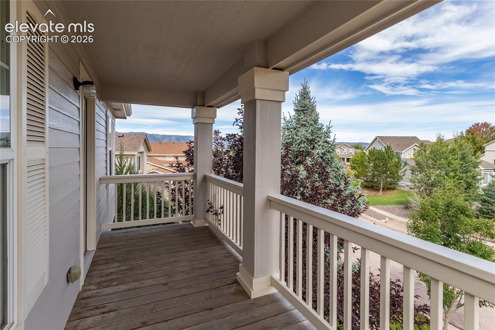 Covered upper balcony offers neighborhood and mountain range views.
