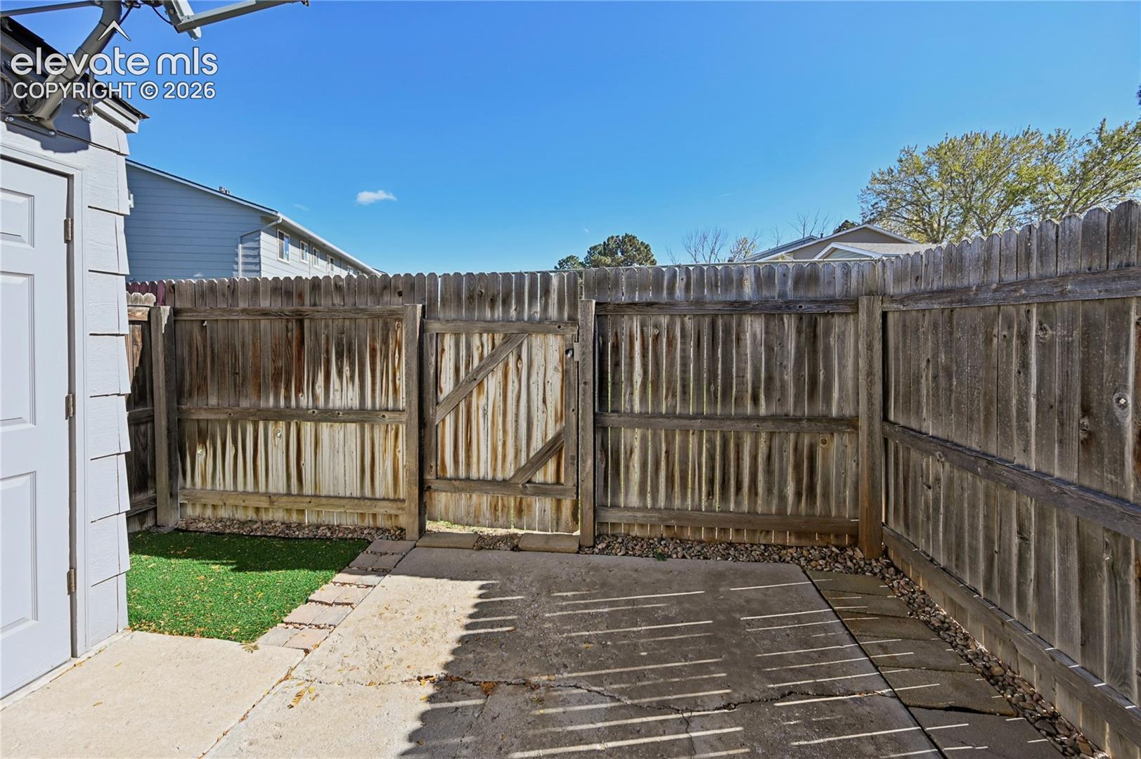 Private back patio, fenced in with storage shed.