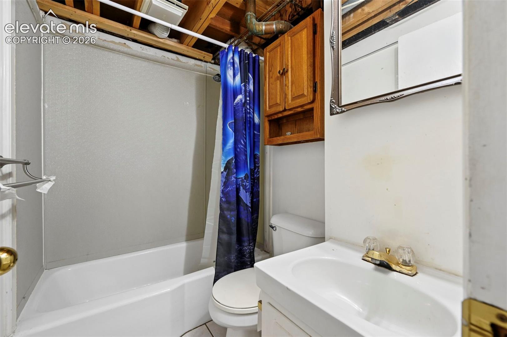 Bathroom featuring a white bathtub, white toilet, and a vanity with a white sink