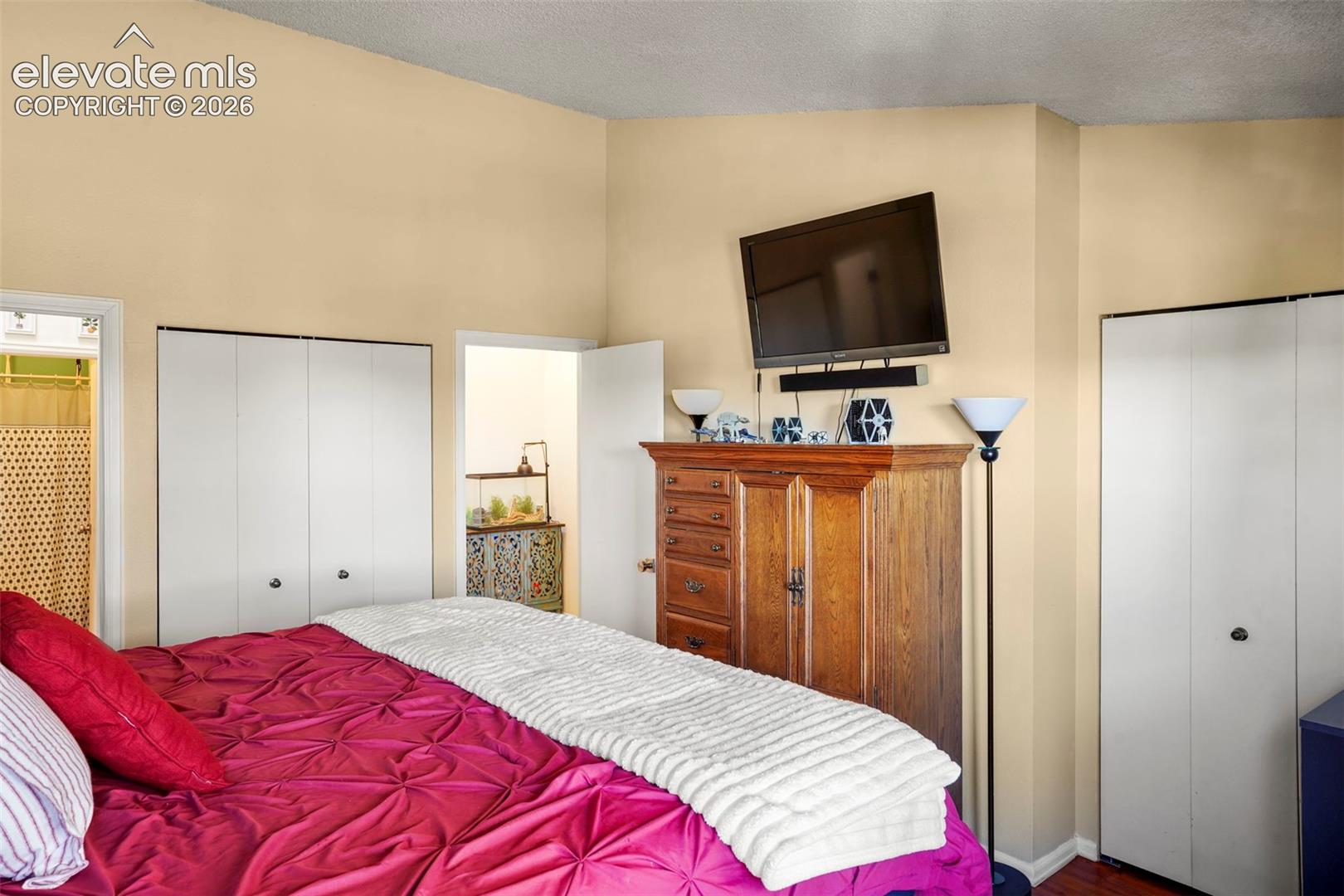 Vaulted ceilings and dual white bi-fold closets