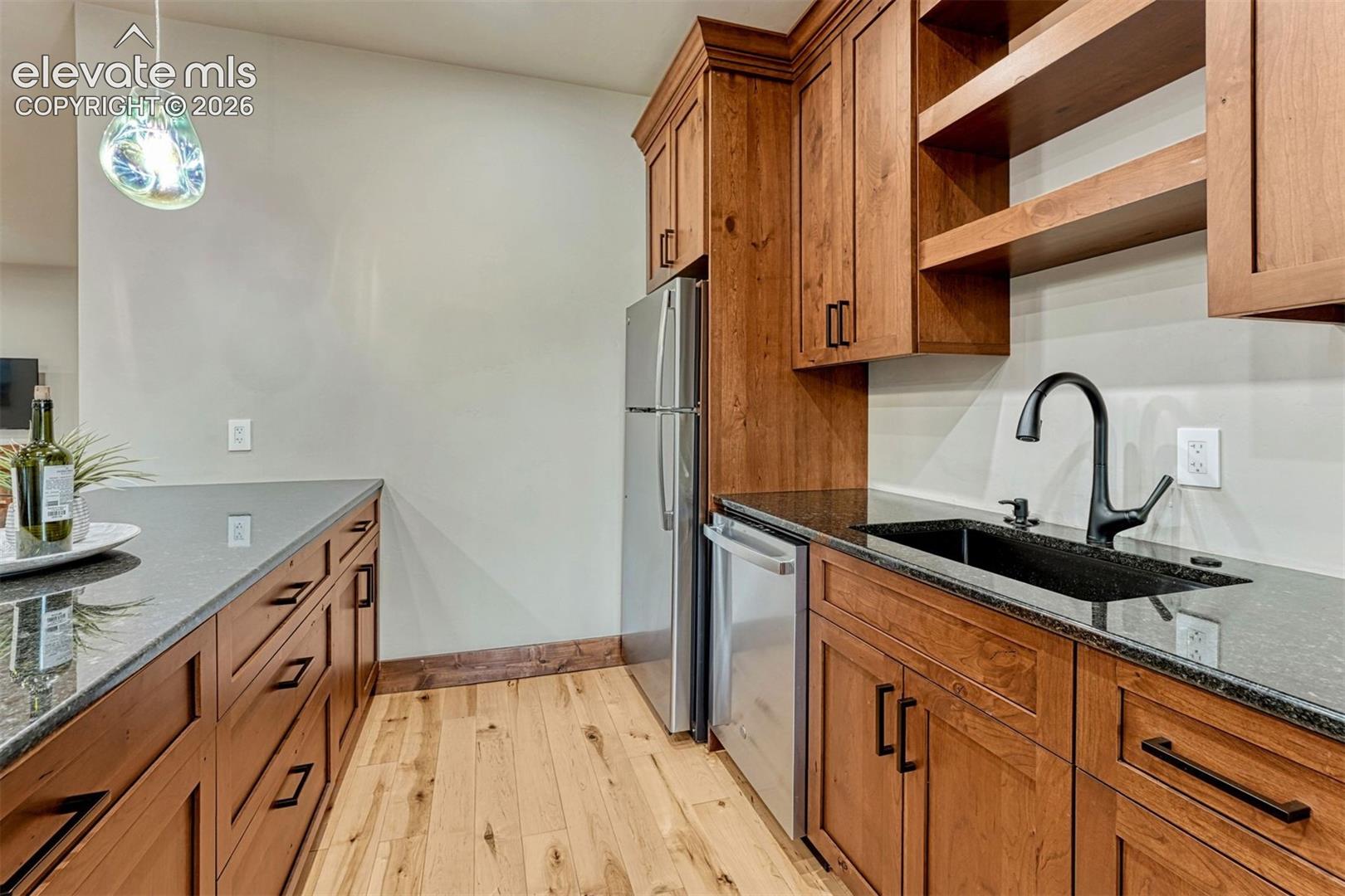 Lower level kitchen with quality cabinets and granite counters. 