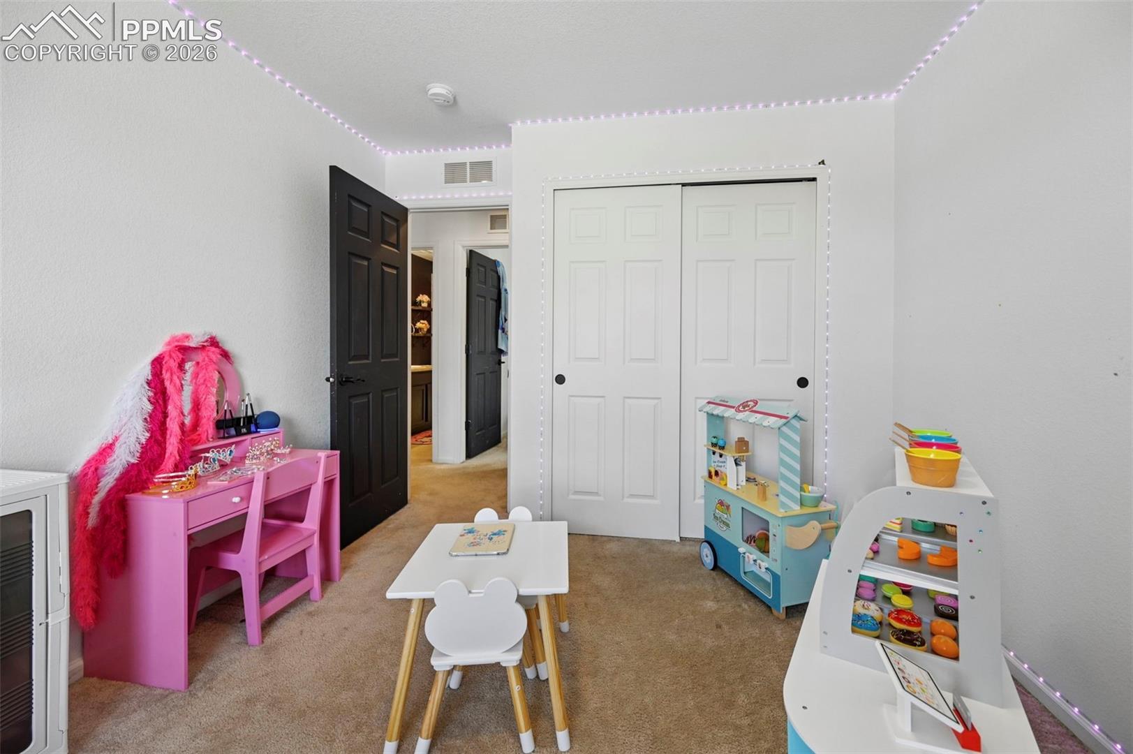 Neutral-toned carpeting and white walls create a versatile interior