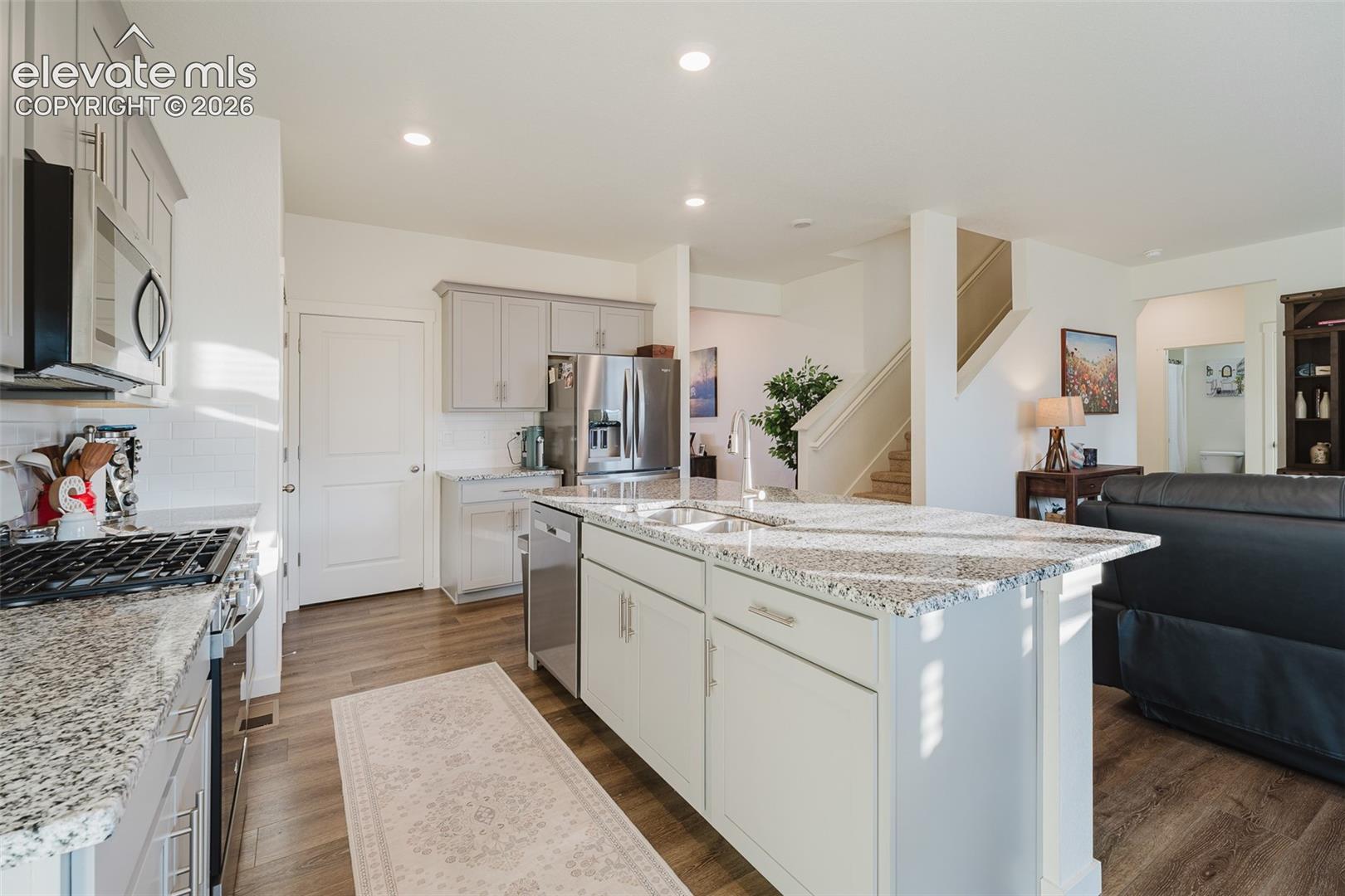 Stainless Steel Appliances include a gas range oven, microwave, dishwasher, & French-door refrigerator.