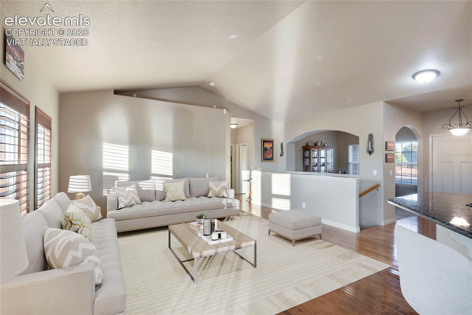 Virtually Staged; wood floor, dining room in right background, vaulted ceilings