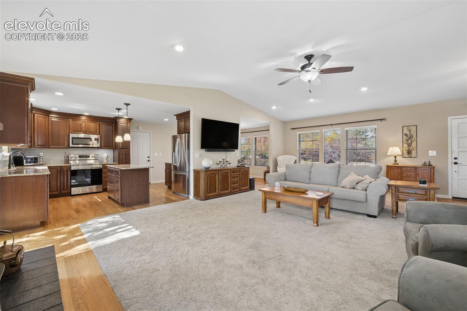 Open concept great room with easy access to updated kitchen and deck
