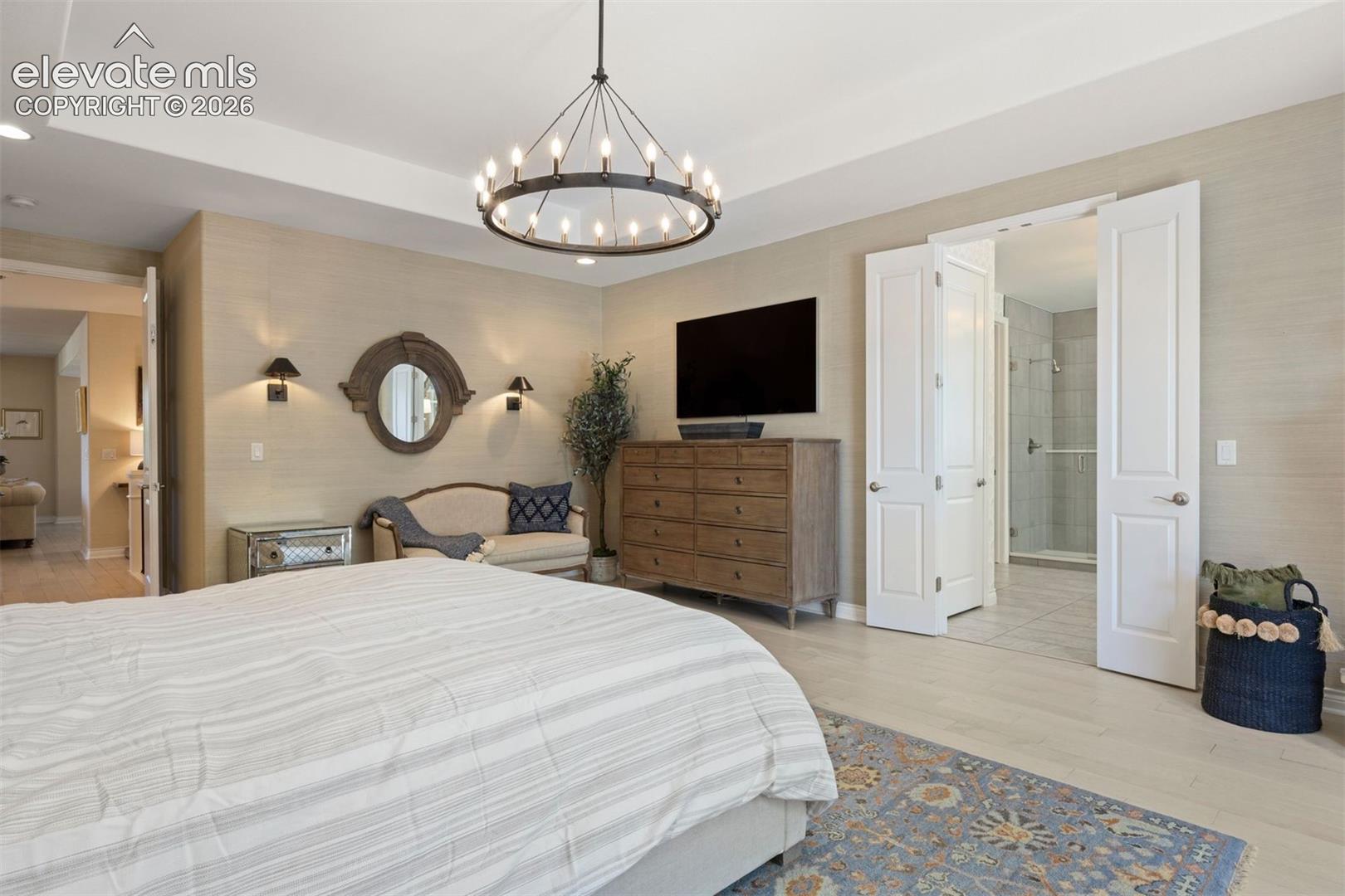 Tray ceiling with recessed lighting and a contemporary chandelier