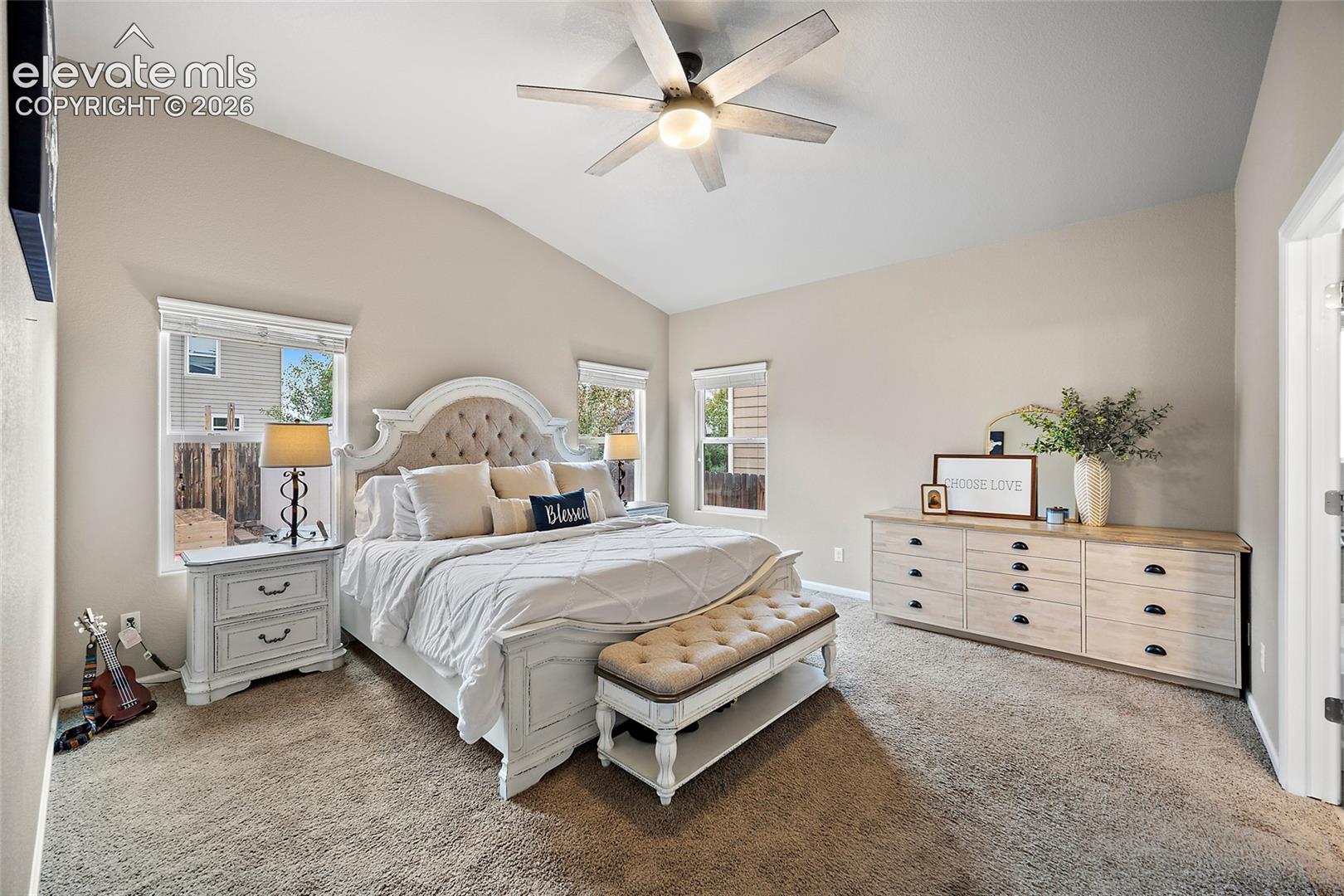 Main-level primary bedroom with an adjoining private bathroom and customized closet storage.
