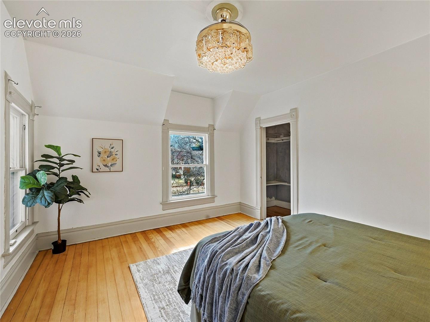 Primary suite w/sitting room, balcony and walk-in closet.