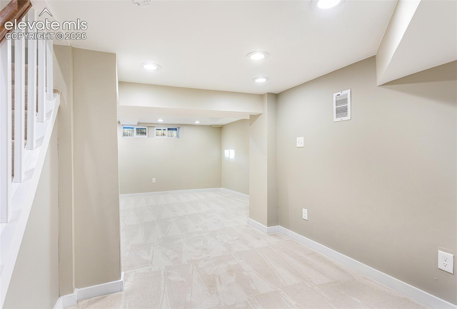 Finished lower level featuring recessed lighting, light-toned carpeting, and neutral wall paint