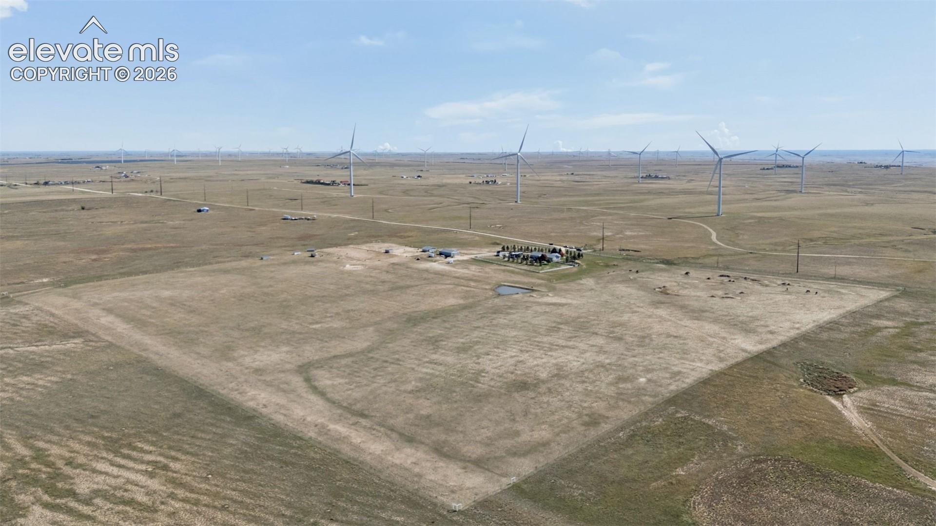 Expansive rural acreage featuring open plains, natural grassland, and a dedicated water pond